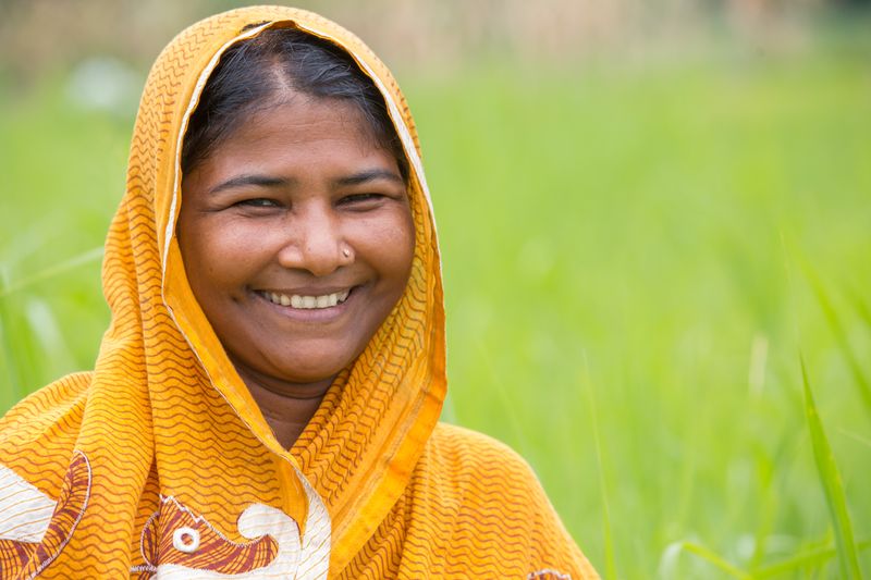 Smiling woman farmer in a rice field
