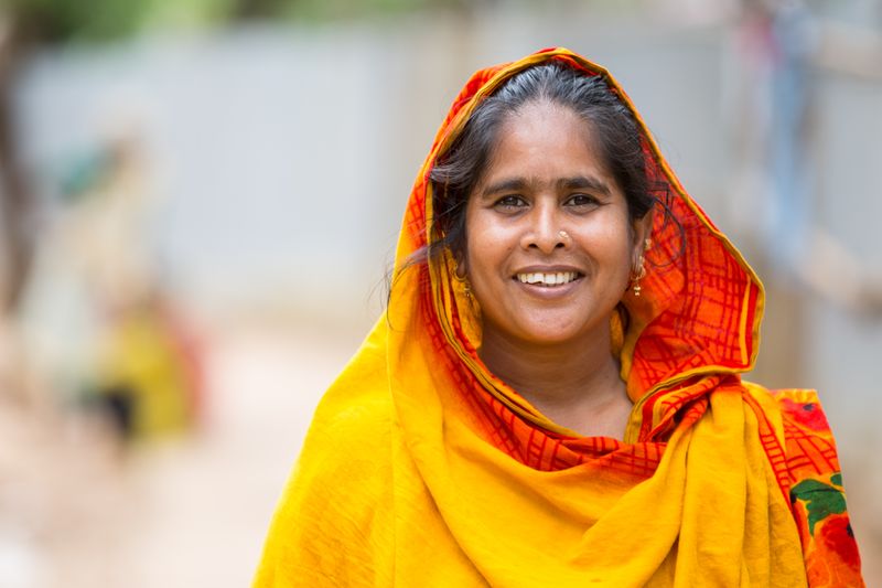 Smiling community member in traditional dress